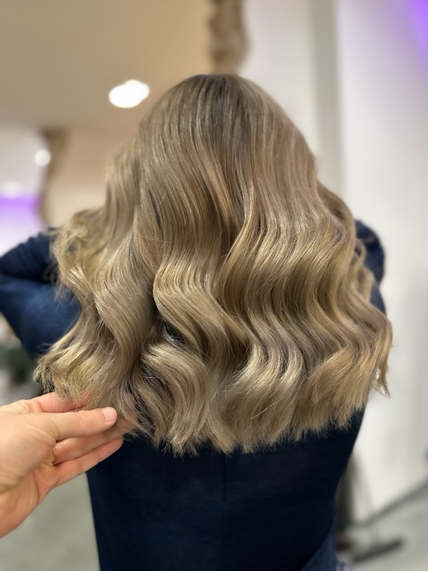 Korekta koloru — elegancki średni blond bob z lśniącymi falami, po metamorfozie